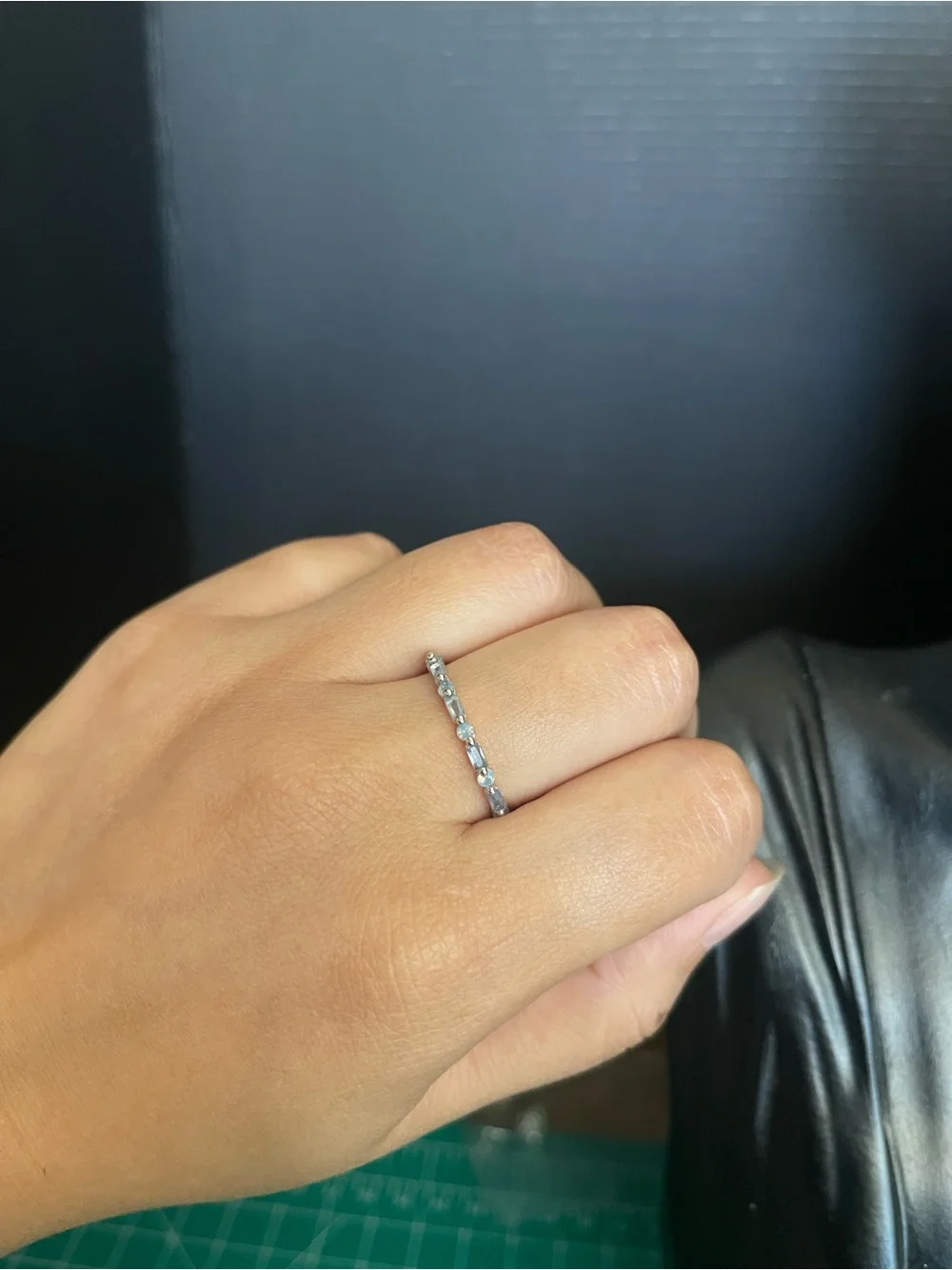 Blue emerald cut and circle cut silver tone band ring